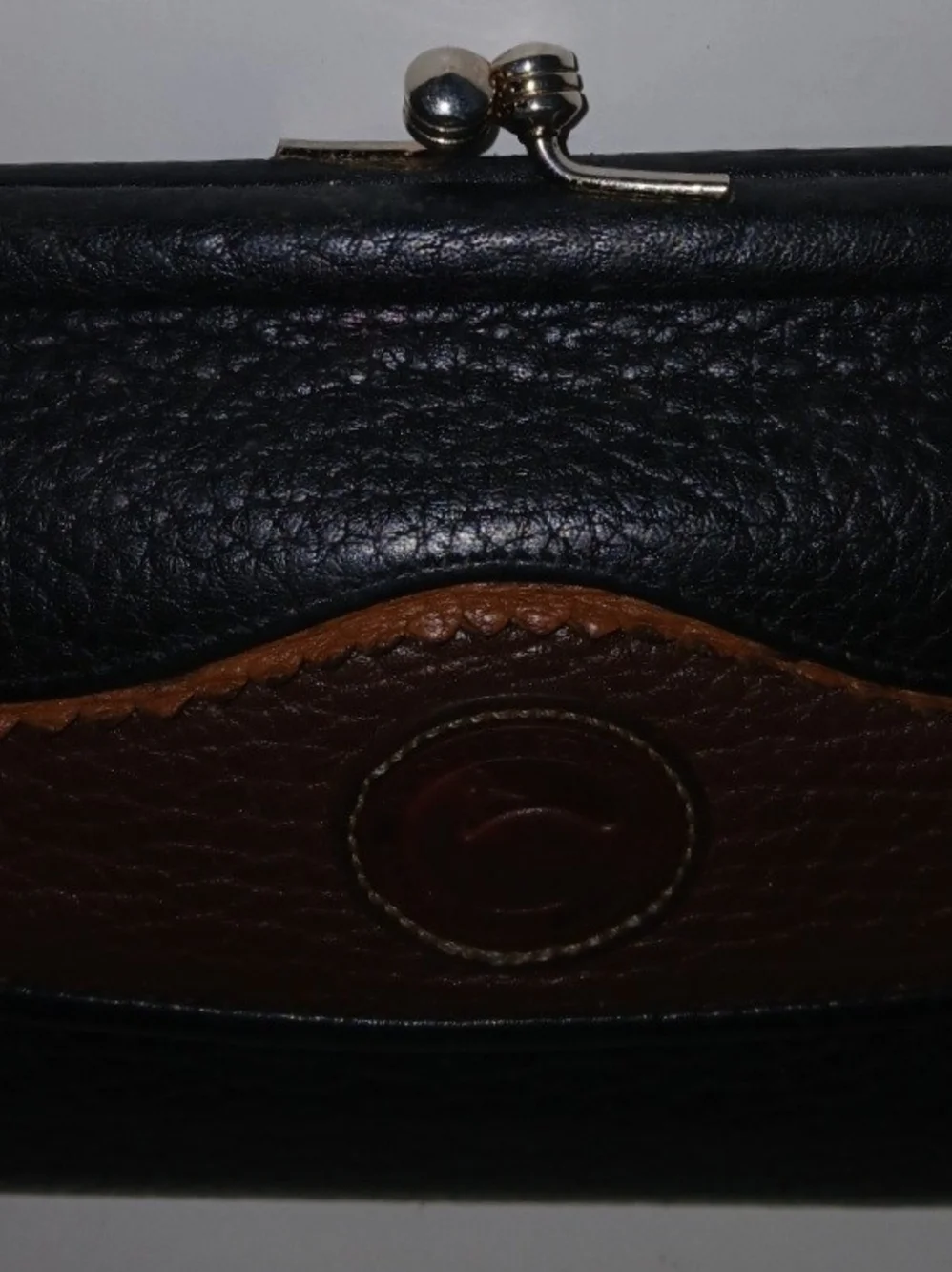 The Dooney & Bourke Black Brown Leather Kisslock Framed Credit Card Trifold